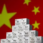 In this photo illustration, metal cubes representing rare earth elements including Scandium (Sc), Yttrium (Y), Neodymium (Nd), Lanthanum (La), and others are stacked in a stepped formation in front of the national flag of China