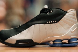 Image of a black and white athletic sneaker with an elaborate cushioning system in its heel.