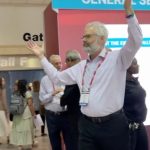 Police escort Dr. Steven Kuhn out of a medical conference in New Orleans for handling out copies